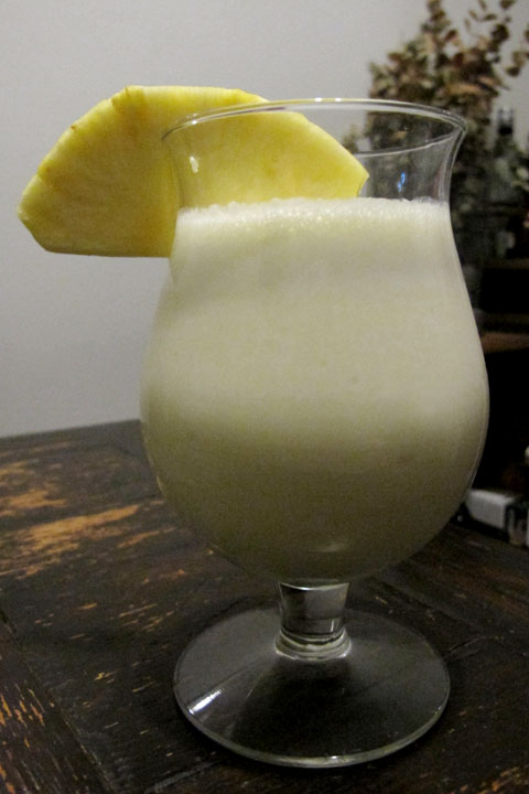 Pina colada, with pineapple wedge