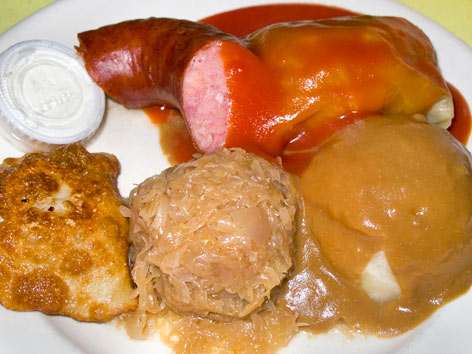 A plate of Polish food with stuffed cabbalge, pierogi, kielbasa and more form Polish Village Cafe in Detroit. 