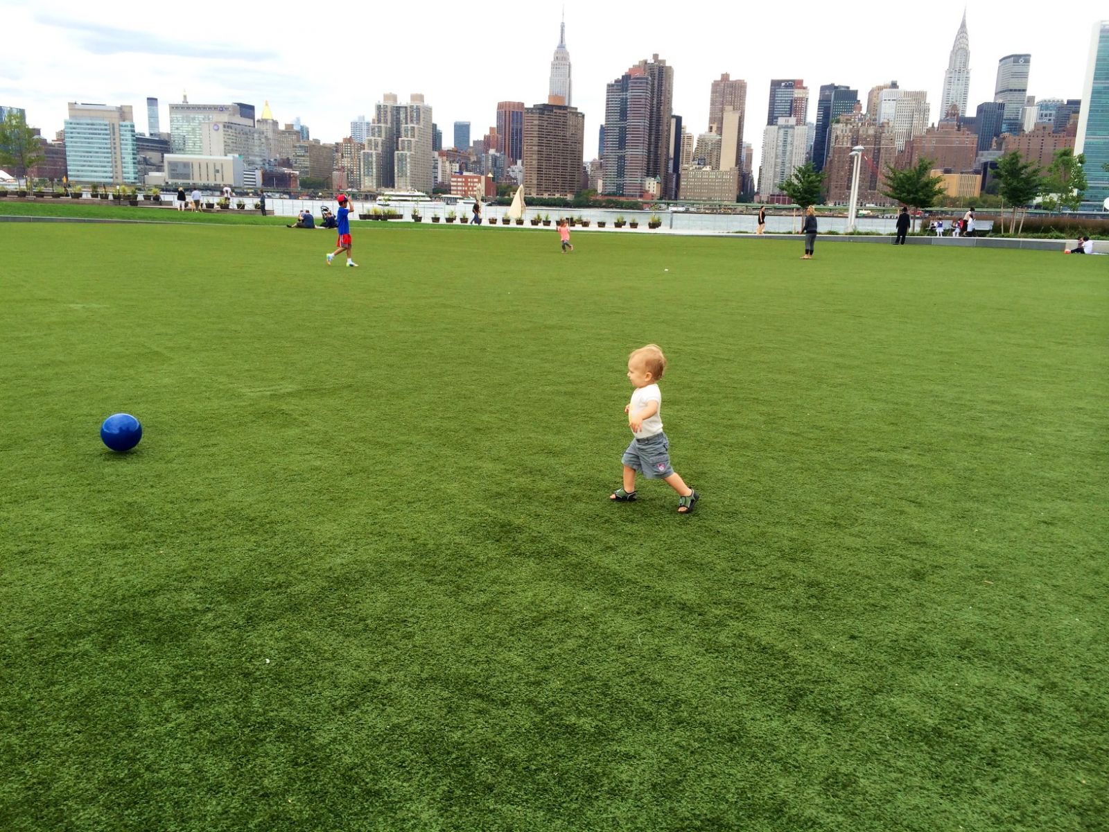Child playing in front of NYC skyline