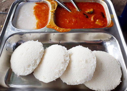 South Indian idli sambhar, steamed rice cakes with a vegetable lentil curry and coconut chutney, as found in Mumbai