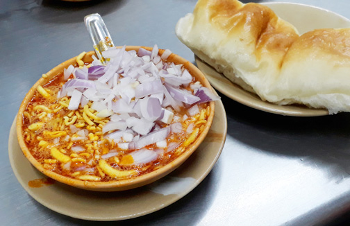 A bowl of misal and bread from Mumbai (sprouts in gravy)