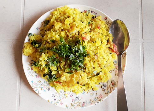A plate of poha, a Marathi breakfast dish made of flattened rice and spices, in Mumbai