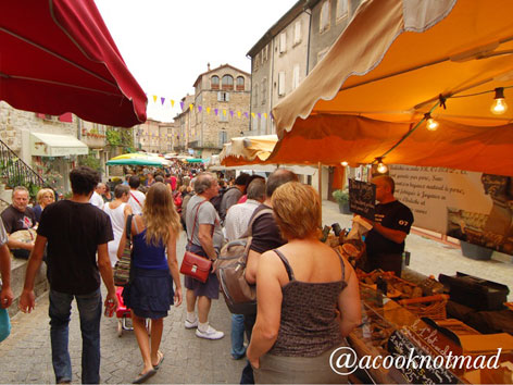 A crowded market scene from Les Vans, France