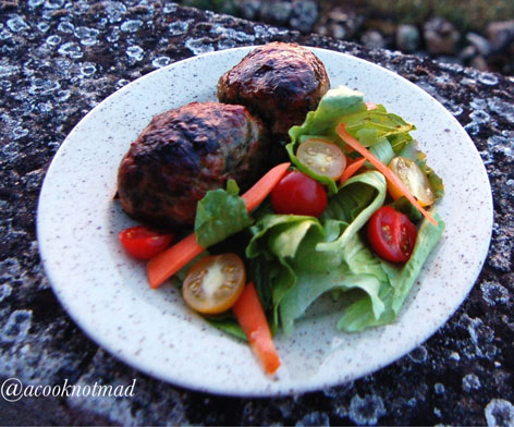 A plate of salad and caillette, a meatball dish from the Ardeche region of France