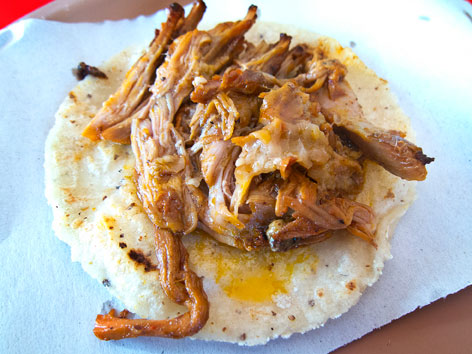 Cochinita pibil taco from a stand in Tulum, Mexico