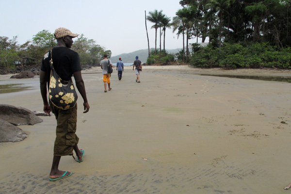 Tourists hike to Black Johnson beach on the Freetown Peninsula, Sierra Leone