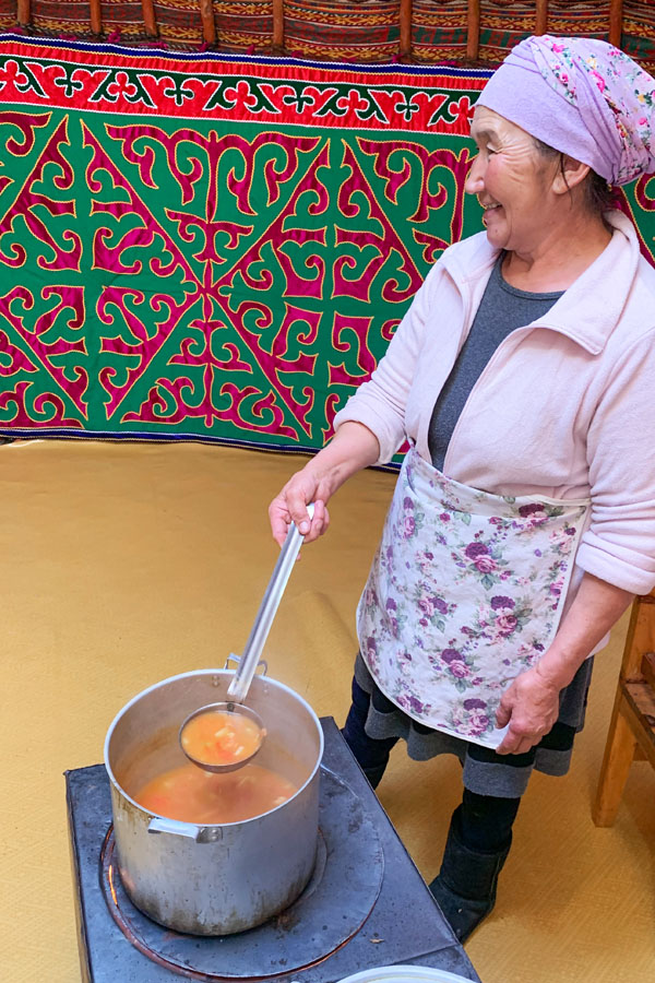 A Kazakh woman with stew in western Mongolia.