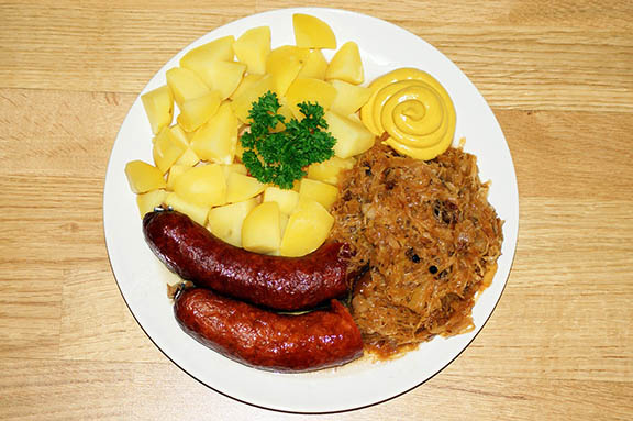 Sauerkraut, a traditional dish in Latvia, pictured with sausage and boiled potato