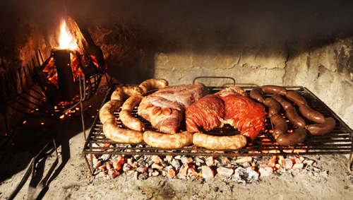 Traditional asada over wood-burning fire in Mendoza, Argentina