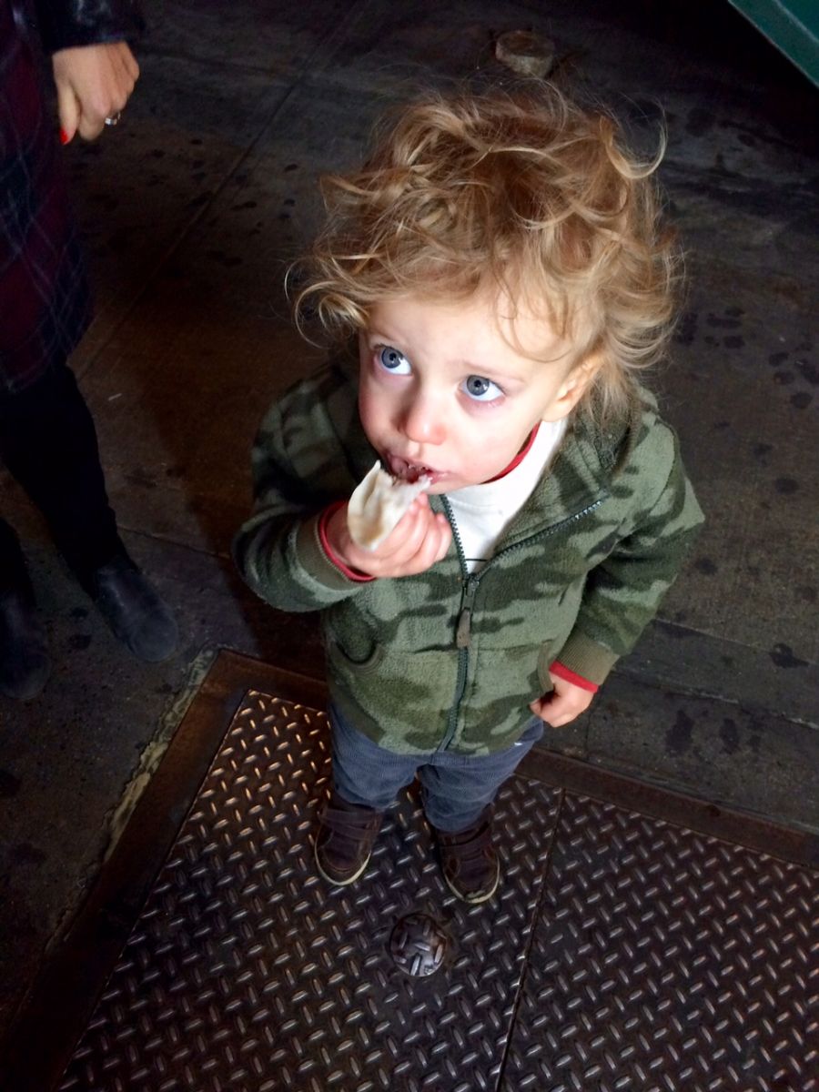 Toddler eating momo dumplings in Queens