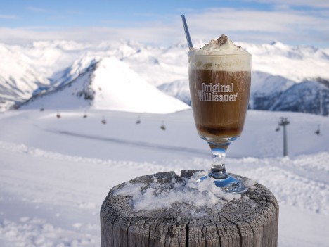 Schumli pflumli, a traditional plum schnapps and coffee drink in the Swiss Alps pictured before a snowy mountain