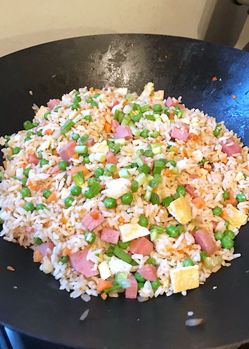 Spam fried rice in the wok, a Polynesian recipe