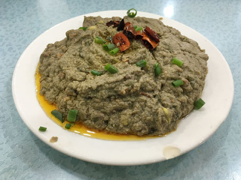 A plate of green madoufu dip in Beijing, kind of a Chinese hummus made of mung bean. 