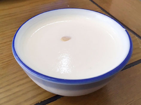 A bowl of jiggly nailao, a type of traditional Beijing yogurt or milk custard. 