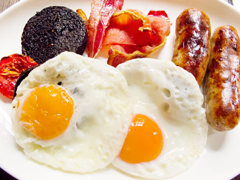 A typical full English breakfast, including black pudding, at Dean Street Townhouse in London, England 