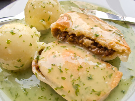 Pie and mash with liquor sauce from a traditional East End pie shop in London, England