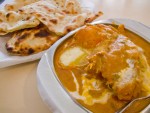Butter chicken and a plate of naan, traditional mughlai food in Agra, India. 
