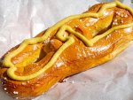 A Philadelphia soft pretzel with mustard from a street cart.