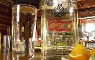 A glass and a bottle of mezcal, distilled from the maguey plant, in Oaxaca.