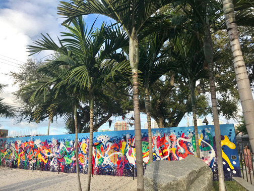 Palm trees in front of an outdoor mural in the Wynwood Walls, Miami, FL.