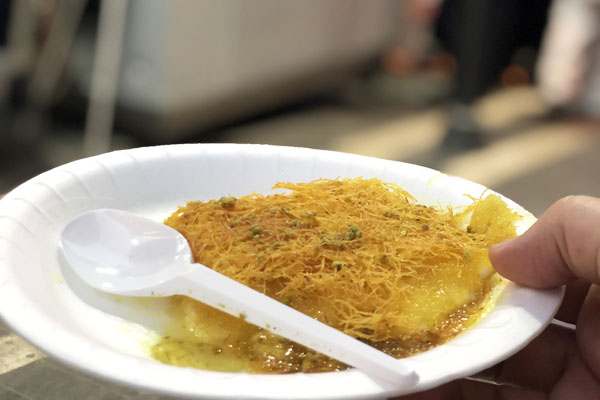 Knafeh, an orange Palestinian dessert that's popular on the street in Amman, Jordan