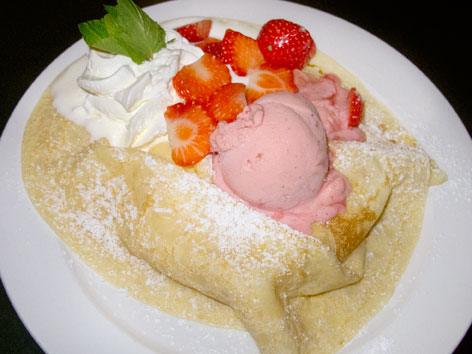 Palacinky, or Czech crepes, are an essential Czech sweet dessert to try in Prague, pictured here with raspberry ice cream and strawberries.
