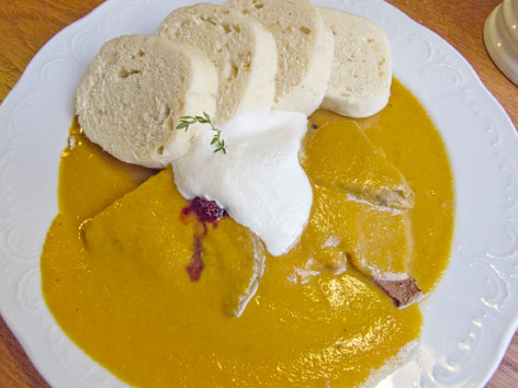 Svickova, or beef in cream sauce with cranberries, is an iconic traditional Czech dish you can try in Prague.