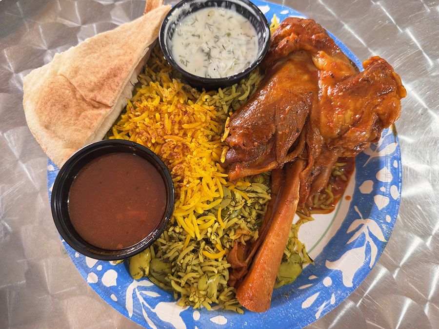 A plate of Persian-style lamb shank with dill rice and fava beans from a Persian food counter inside the Green Bazaar grocery store in Lake Worth, FL.