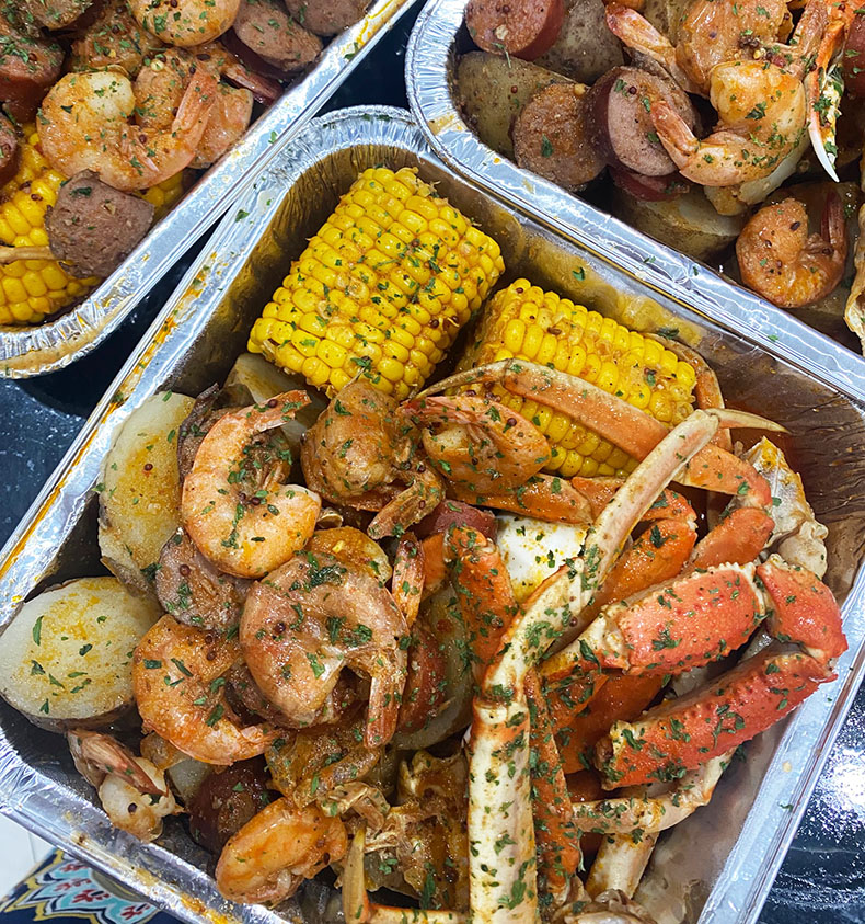 Creole-style crab and shrimp boil with corn and potatoes from Haitian home cook in Lake Worth, Florida