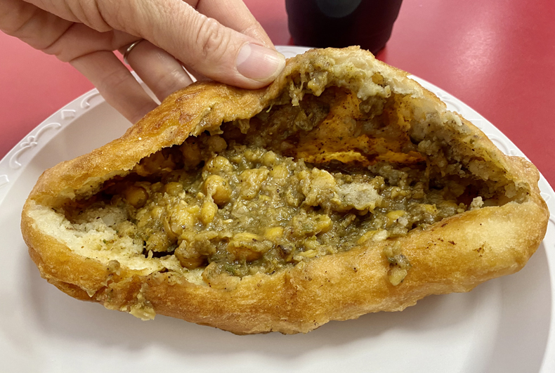 An Indo-Caribbean aloo pie stuffed with channa, chickpea curry, from Richmond Hill, Queens