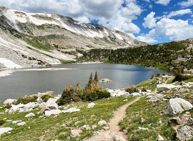 The Lakes Trails winds around a lake and Medicine Bow peak in the Snowy Range