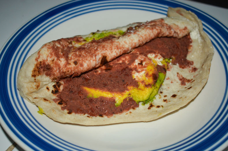 A baleada, a folded tortilla over beans, cheese, and cream, is one of Honduras' most popular food.