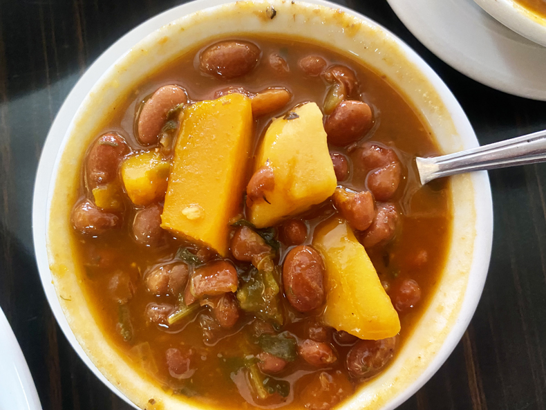 A bowl of soupy beans, or habichuelas, studded with squash, from a restaurant in Puerto Rico