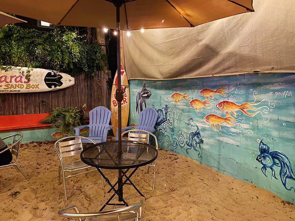 The sandy backyard dining area at Mara's Ice Cream in Rockaway Beach