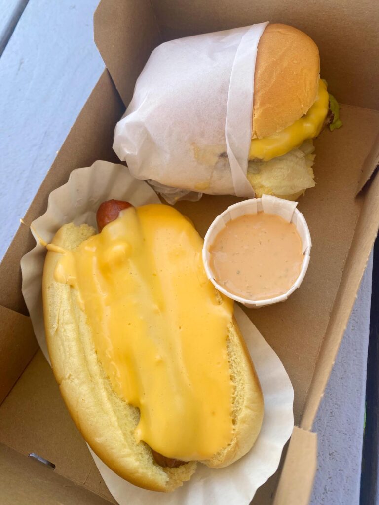 A cheeseburger and cheese dog from Ripper's, one of many popular beachfront restaurants in Rockaway Beach