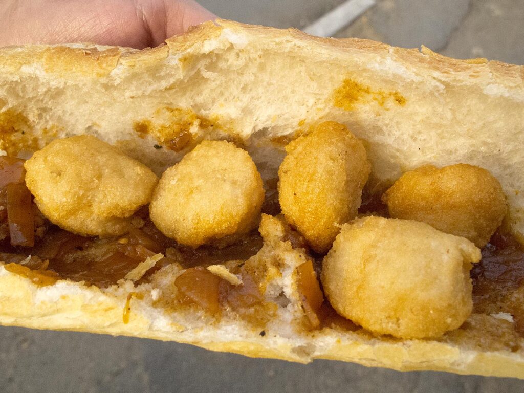 A sandwich of accara from a street stall in Dakar, Senegal.