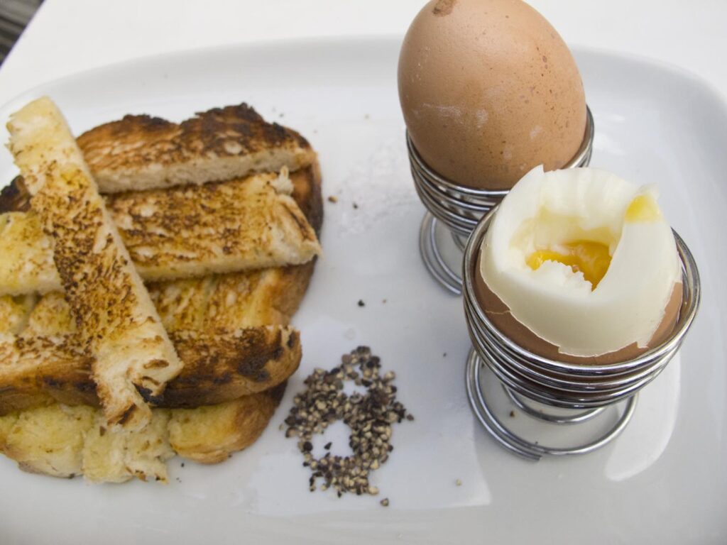 Boiled eggs and soldiers, or sliced toast, from a London cafe, England