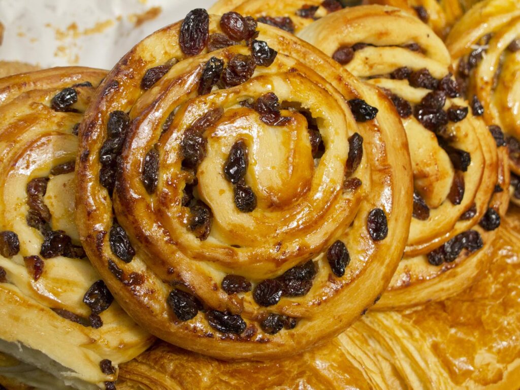 A pile of fresh chelsea buns from The Flour Station in London, England.