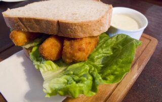 A fish finger sandwich with lettuce and tartar sauce from a pub in London, England
