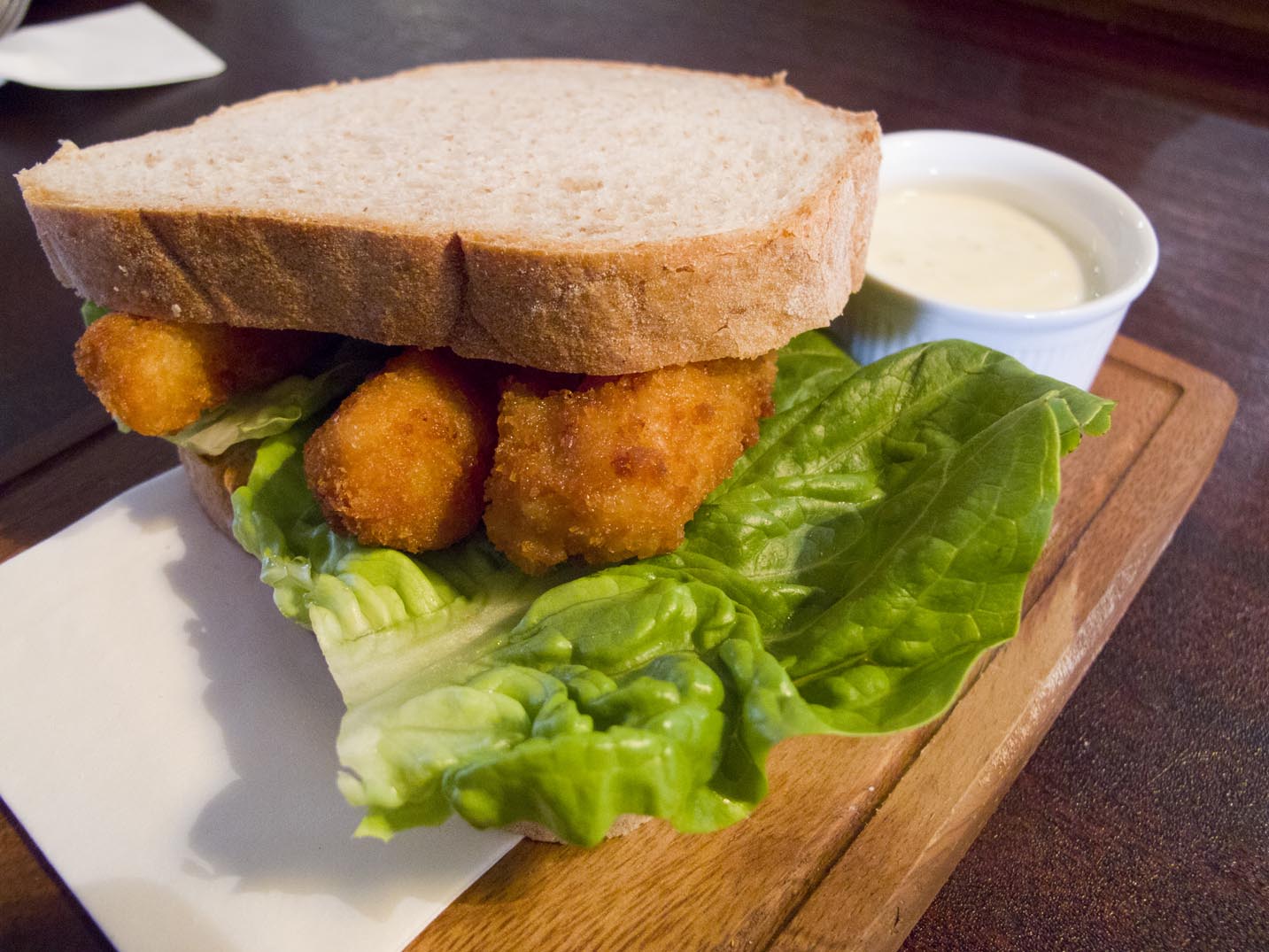 A fish finger sandwich with lettuce and tartar sauce from a pub in London, England