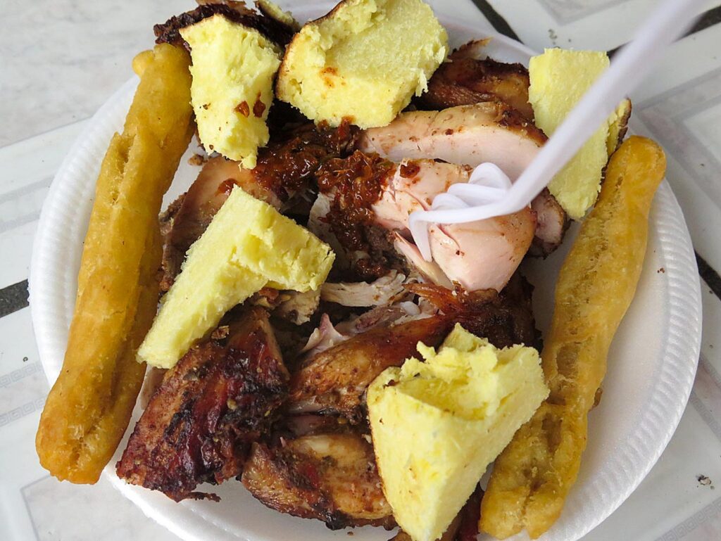 Plate of jerk chicken with festival and yam from Boston Jerk Center, Portland, Jamaica