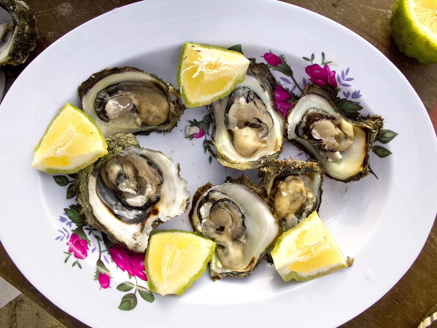 A plate of local oysters with lemon from Bureh Beach in Sierra Leone.