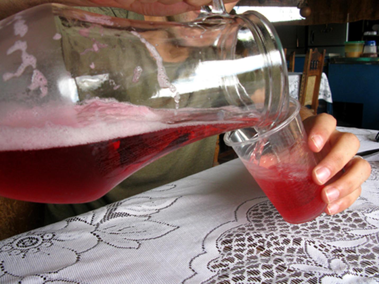 Pouring refajo from a glass pitcher in San Gil, Colombia.