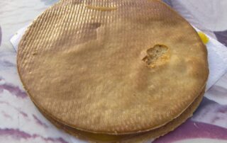 A crunchy fresh-baked stroopwafel from Lanskroon bakery in Amsterdam, the Netherlands.