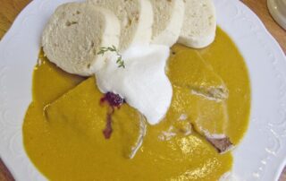 Svícková na smetane, a typical Czech dish of beef in cream sauce, at a Czech pub in Prague