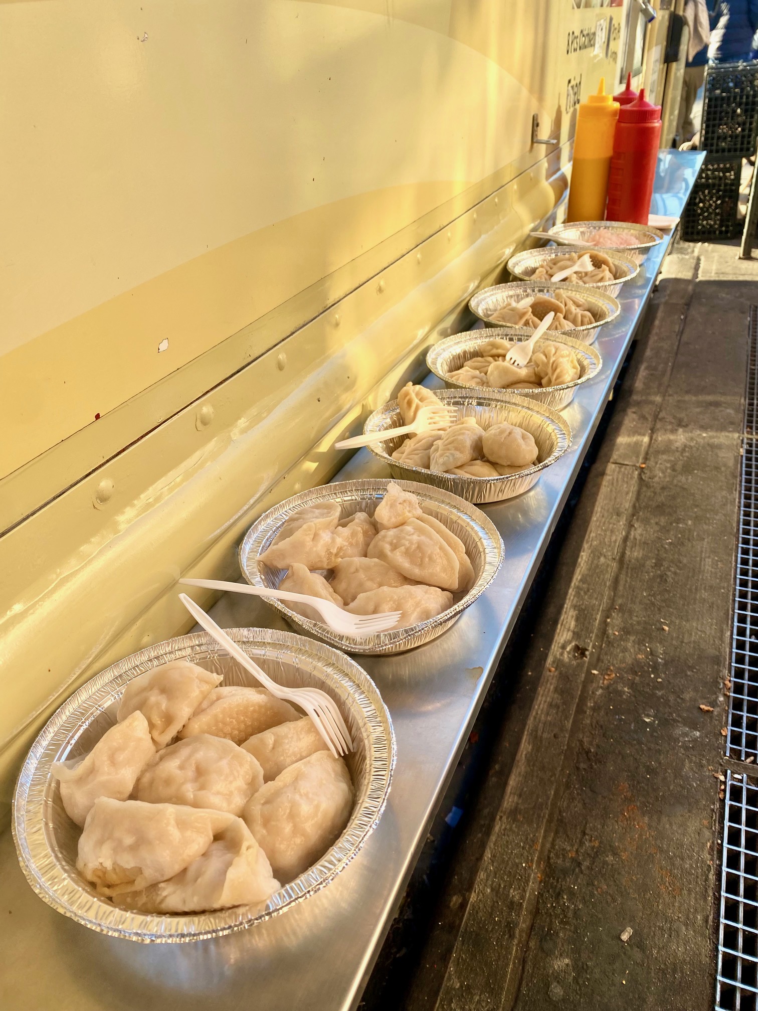 Tibetan momo (dumplings) lined up on a truck in Jackson Heights for a food tour.
