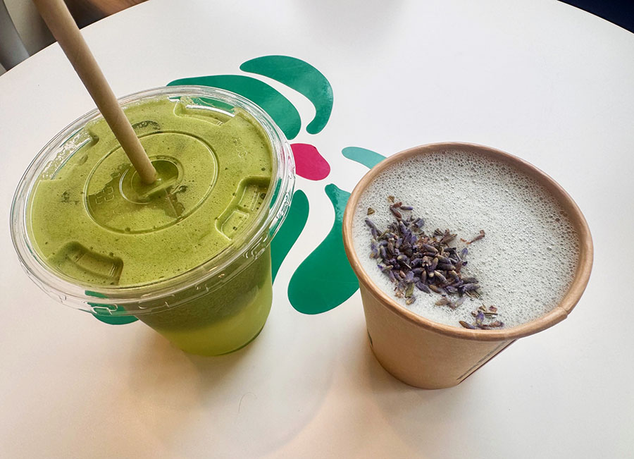 A green juice and a lavender latter are pictured on a table inside Vitality, a new juice shop and cafe in Sunnyside, Queens.