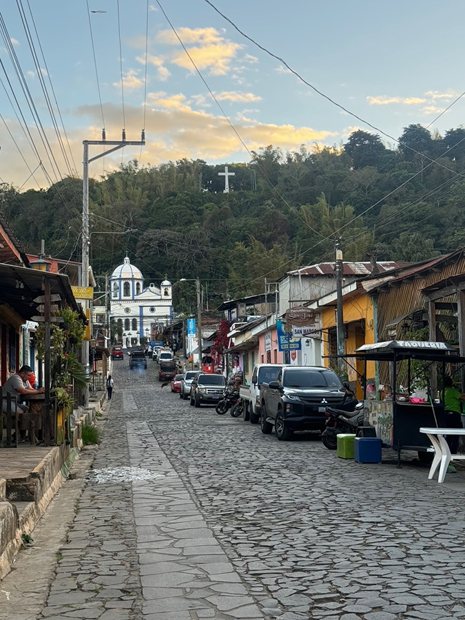A quaint cobblestone street and old church in the colonial pueblo of Ataco, El Salvador.