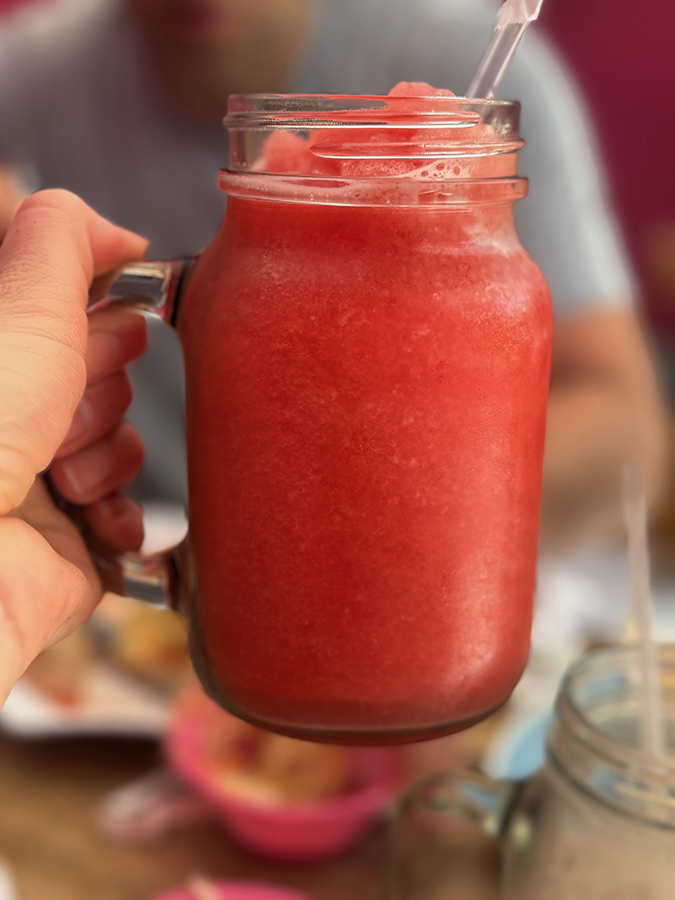 An icy pink-colored fruit smoothie near the beach in El Salvador.